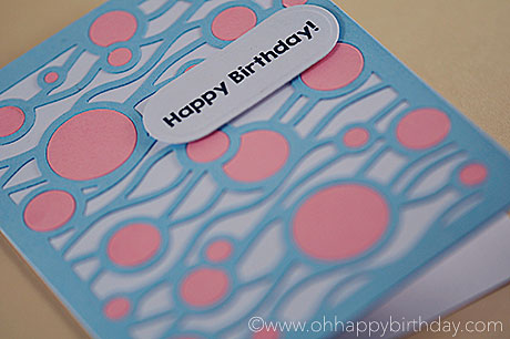 A cool Happy Birthday card for boys or girls in light blue and pink against a white background.